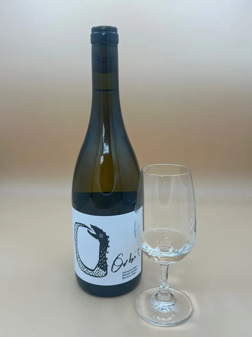 A bottle of Ochi's Grenache Blanc from McLaren Vale beside an empty tasting glass